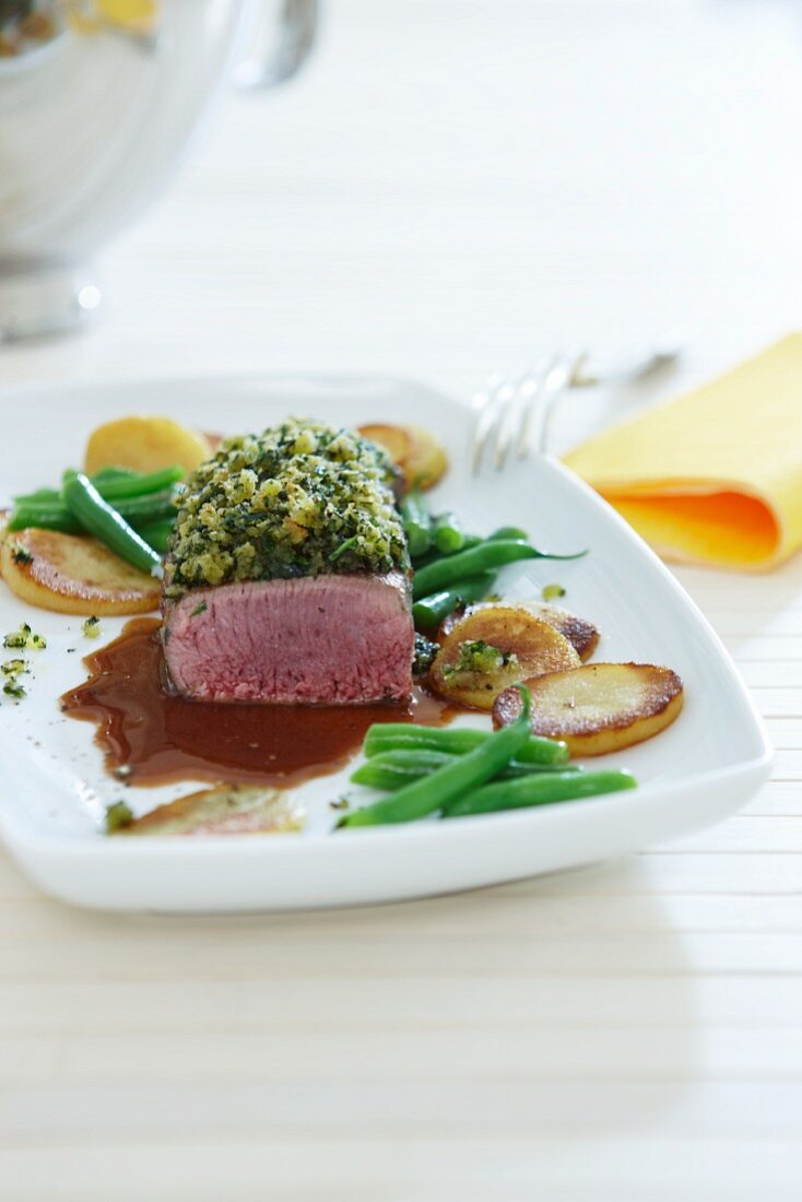 Saddle of lamb with beans and fried potatoes