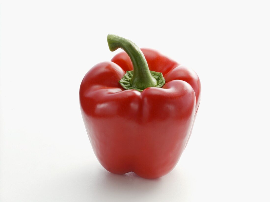 A red pepper on a white surface