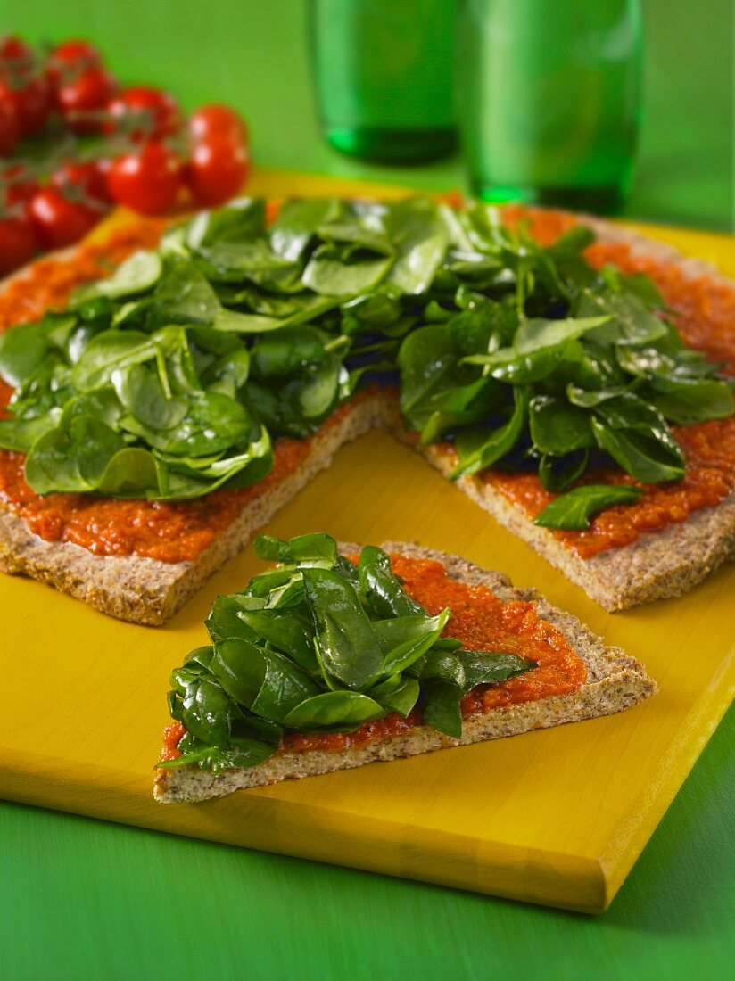 Buckwheat pizza with sunflower seeds, tomatoes and spinach