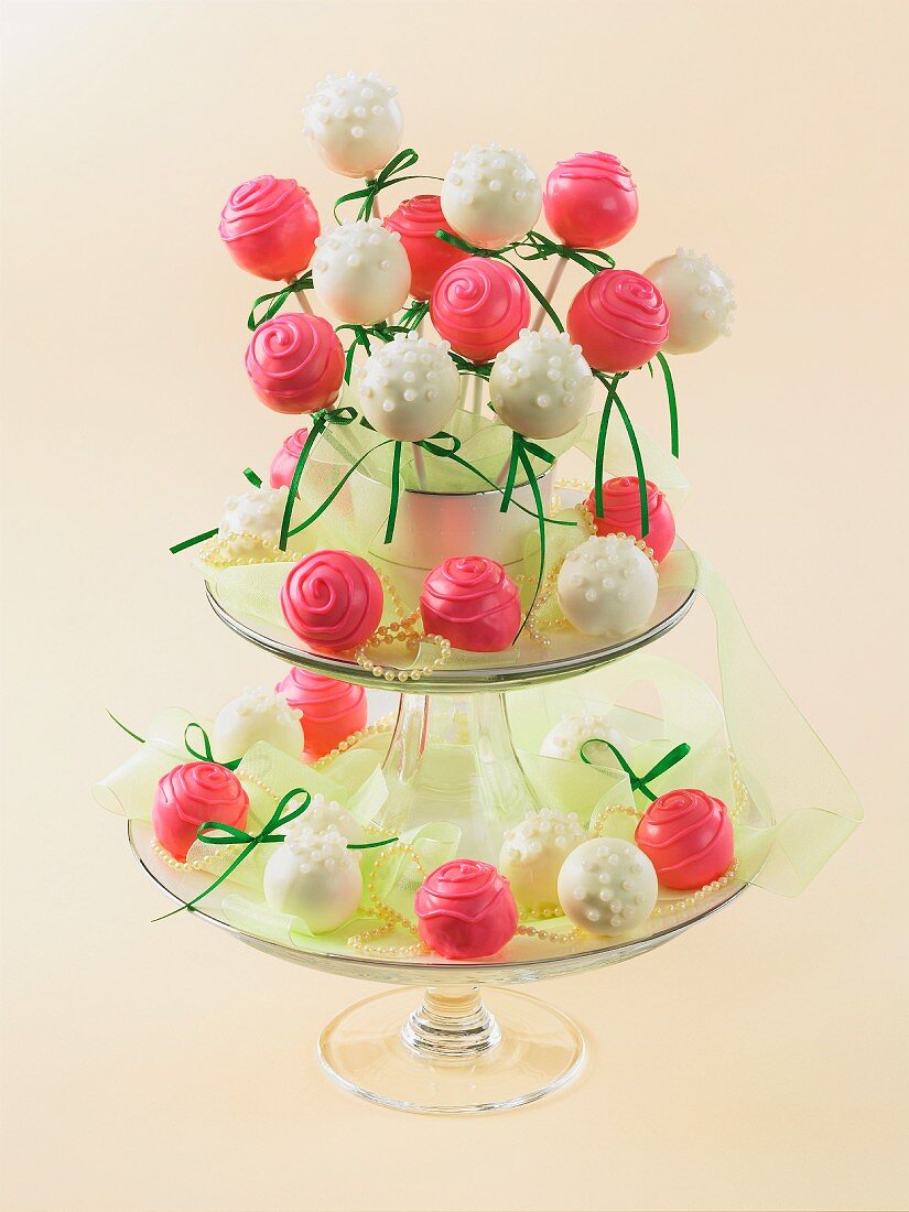Pralines and cake pops on a tiered cake stand