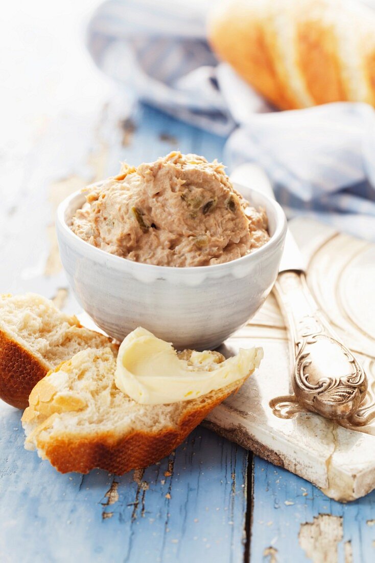 Tuna pâté with white bread on a blue wooden surface