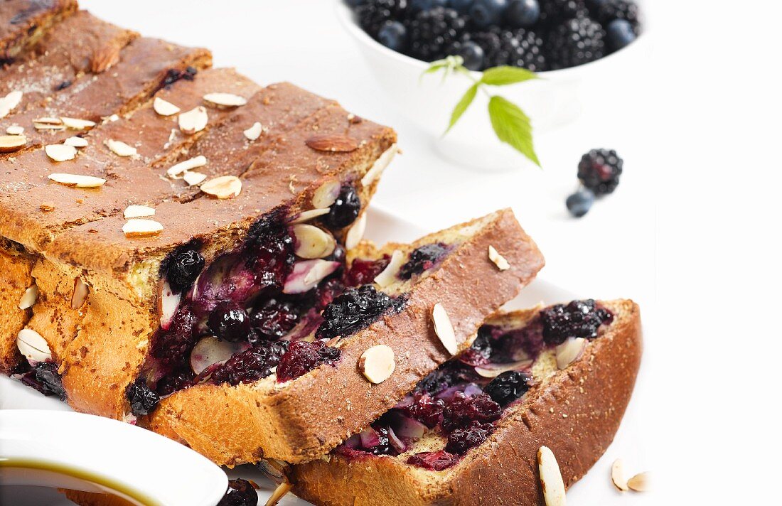 Berry cake baked in a loaf tin, cut into sliced