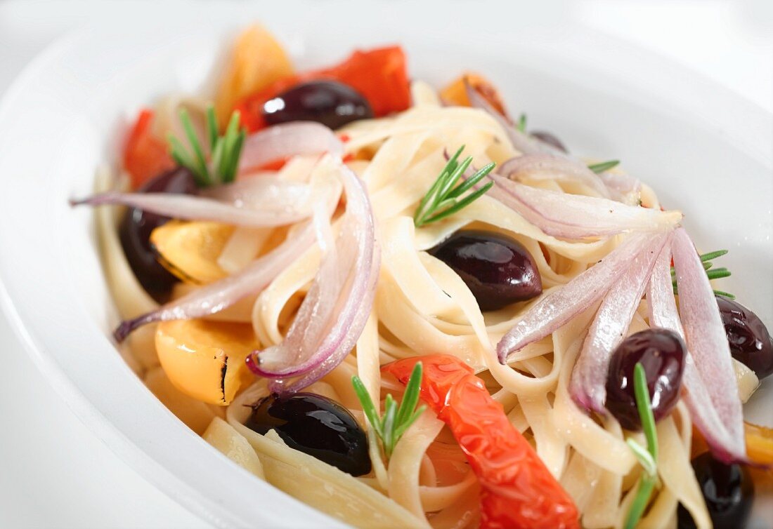 Ribbon pasta with peppers, black olives, onions and rosemary