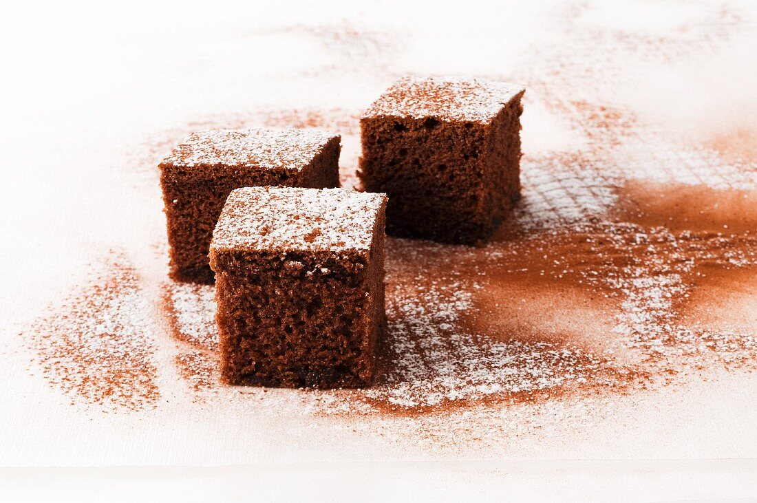 Cubes of chocolate cake with icing sugar