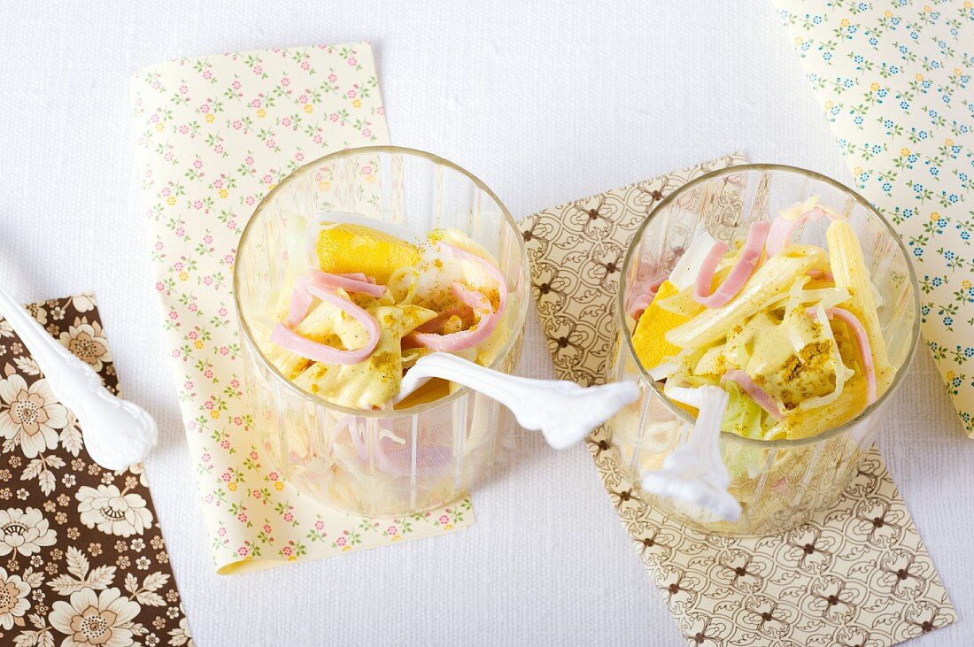 Pasta salad with curry and strips of ham