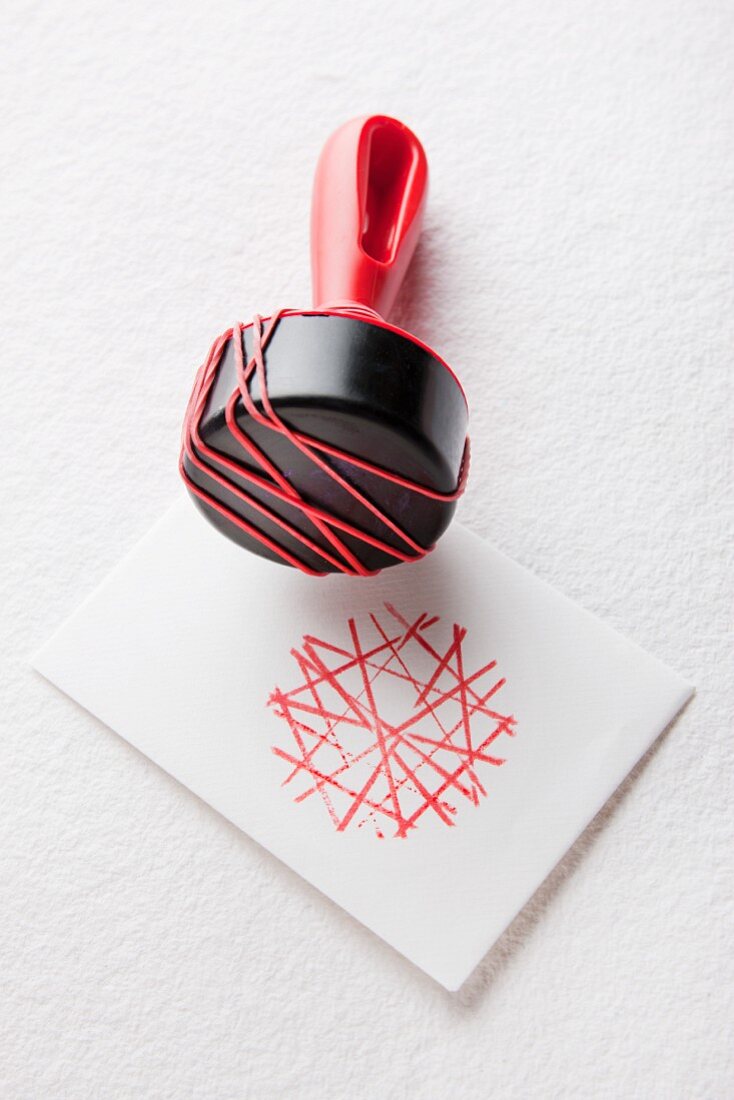 Rubber bands stretched around stamp handle to create graphic pattern