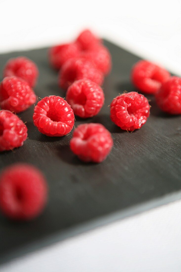 Raspberries on a black board