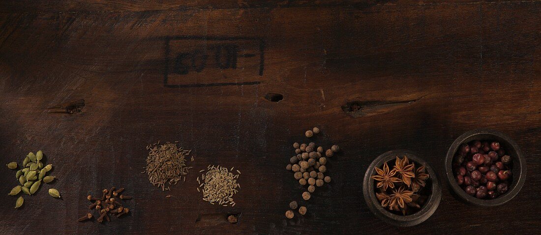 Assorted spices on a wooden surface