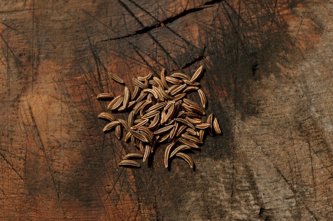 Caraway seeds on a wooden surface