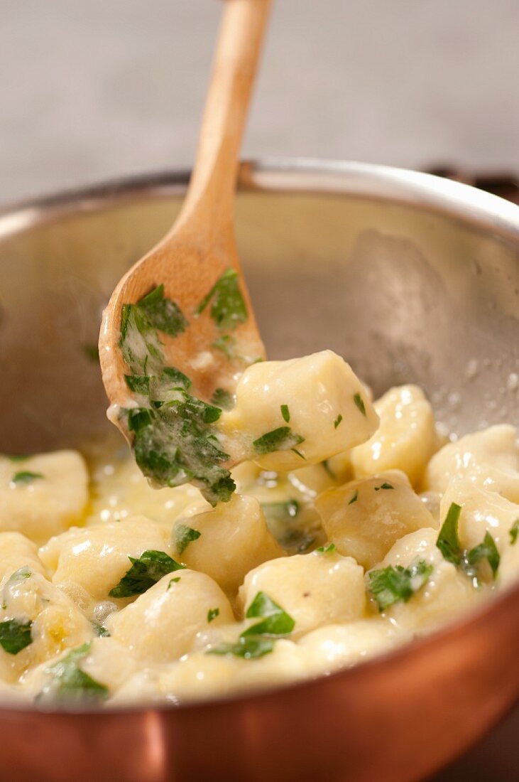 Potato gnocchi with parsley being prepared