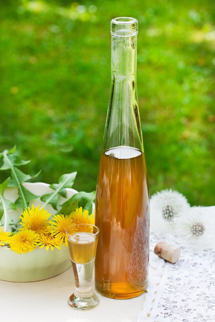 Bottle and glass of dandelion flower liqueur