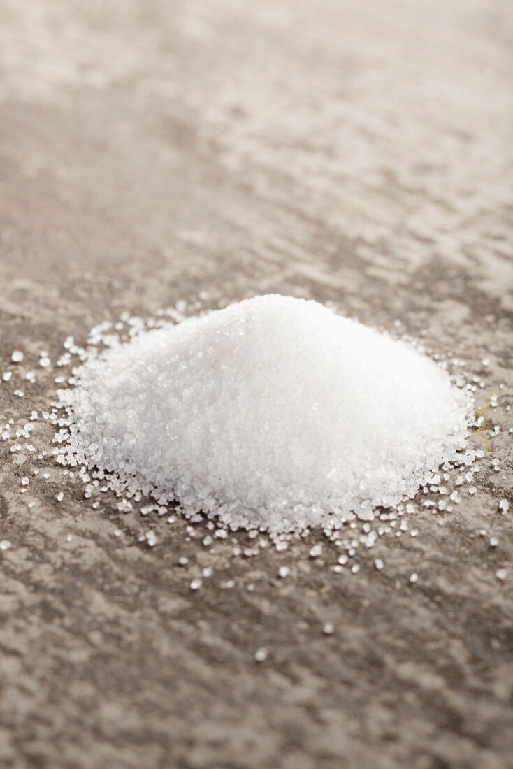 Granulated sugar on a grey surface