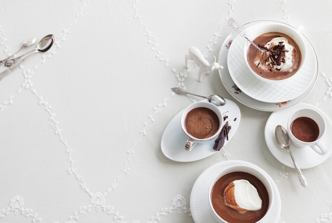 Four cups of drinking chocolate, with and without whipped cream
