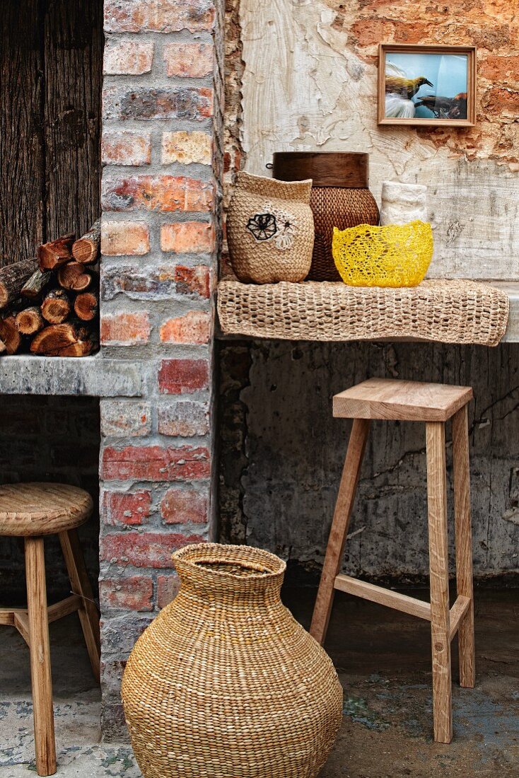 Rattan basket on floor in front of brick License image