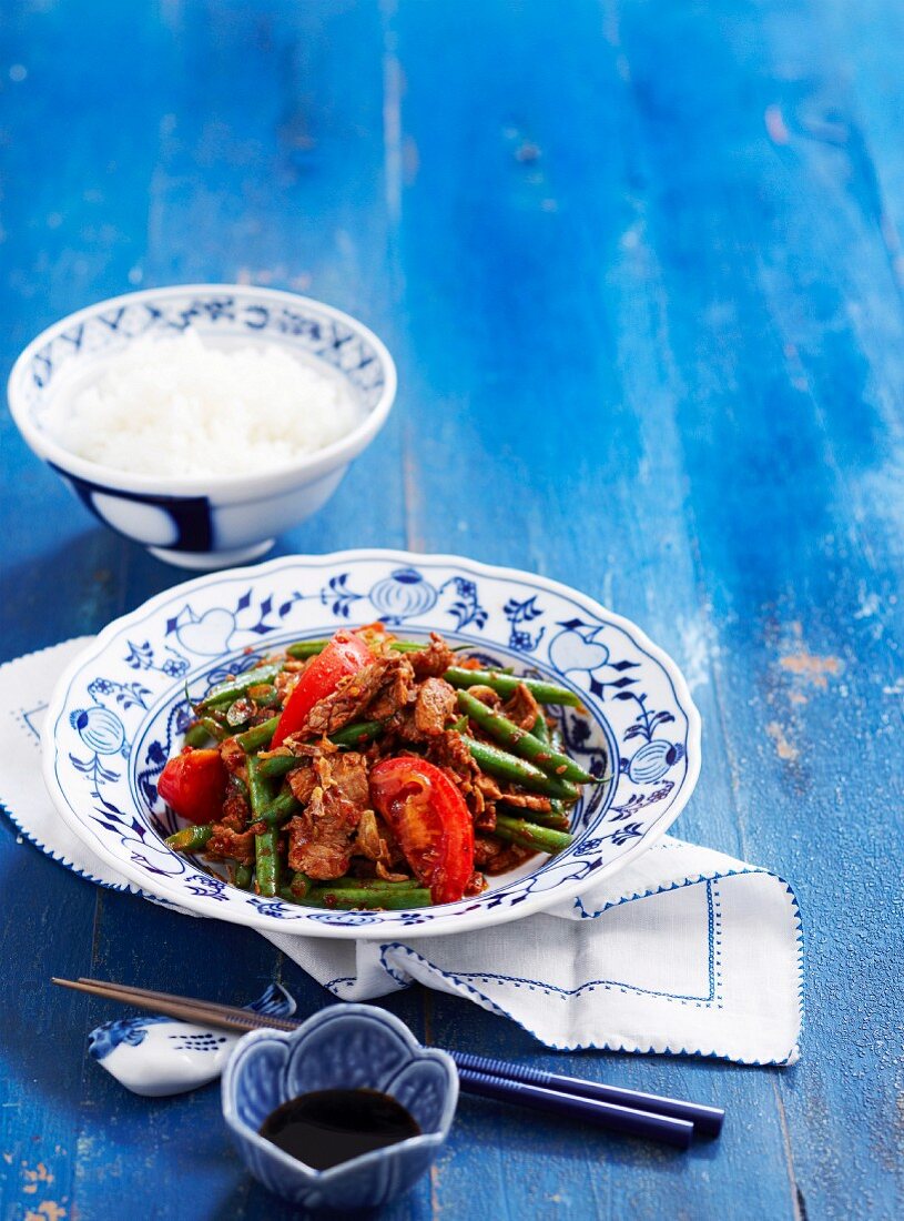 Pork with chilli jam, tomatoes, green beans and rice (Asia)