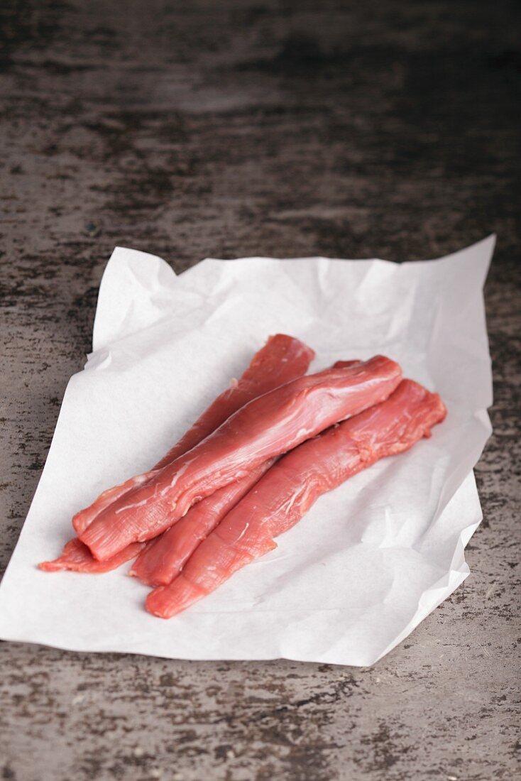 Lamb fillets on baking parchment