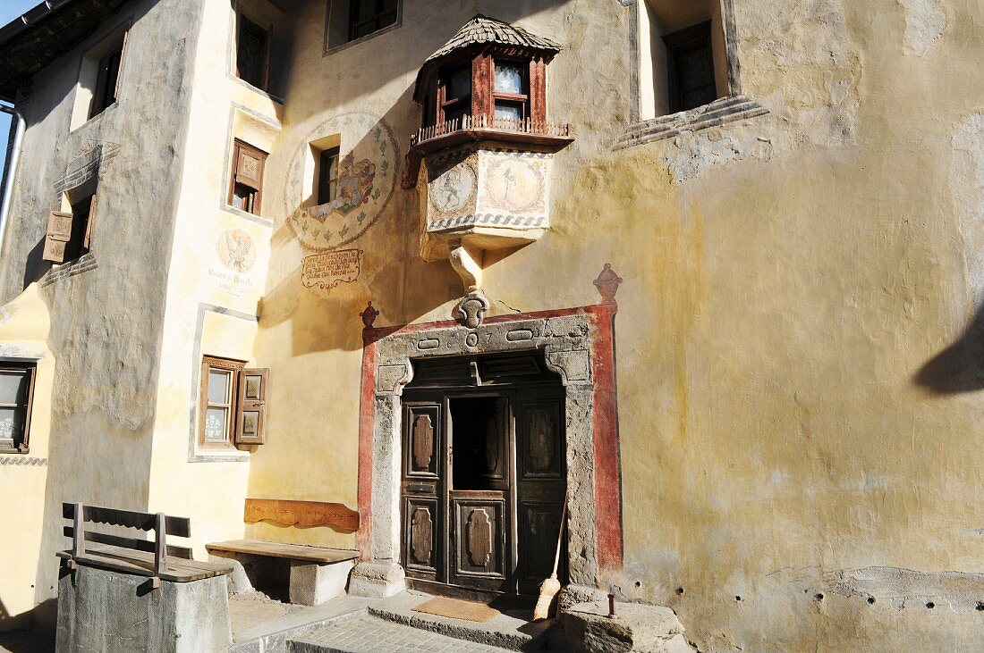 Facade with crest of old Buendner family in Val Sinestra in Graubuenden canton, Switzerland