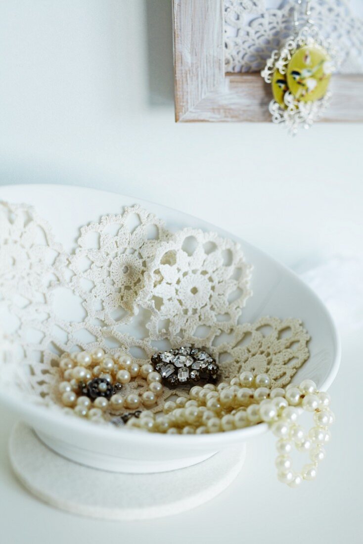 China jewellery dish lined with crocheted doily