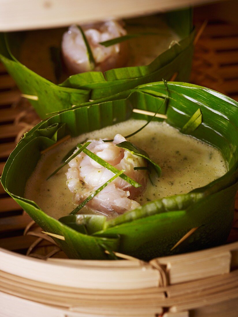 Green fish curry in a banana leaf bowl