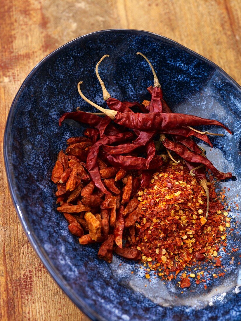 Dried chillies, whole and ground, in a blue dish