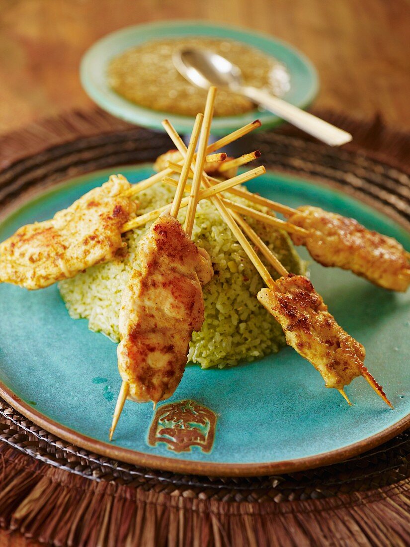 Satay skewers on a timbale of rice with peanut sauce