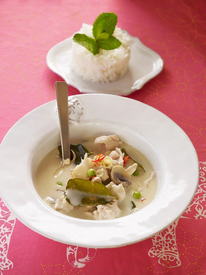 Asian coconut milk soup with chicken, vegetables and lime leaves