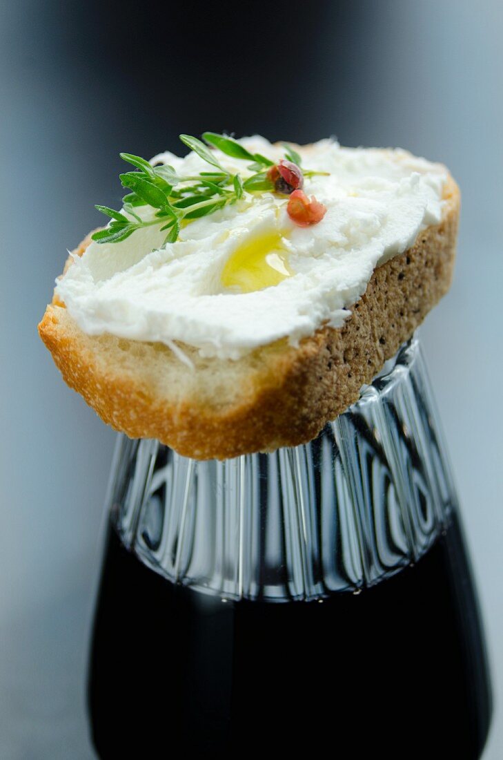 Crostini with cheese on a glass of wine