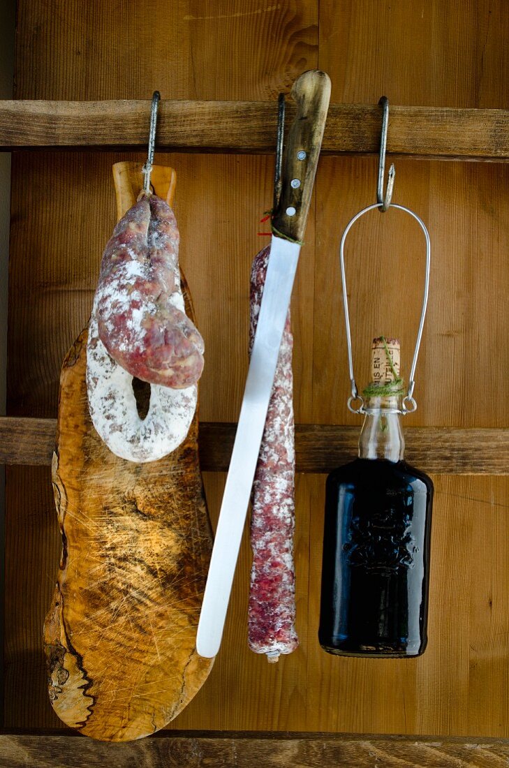 A still life with salami and wine