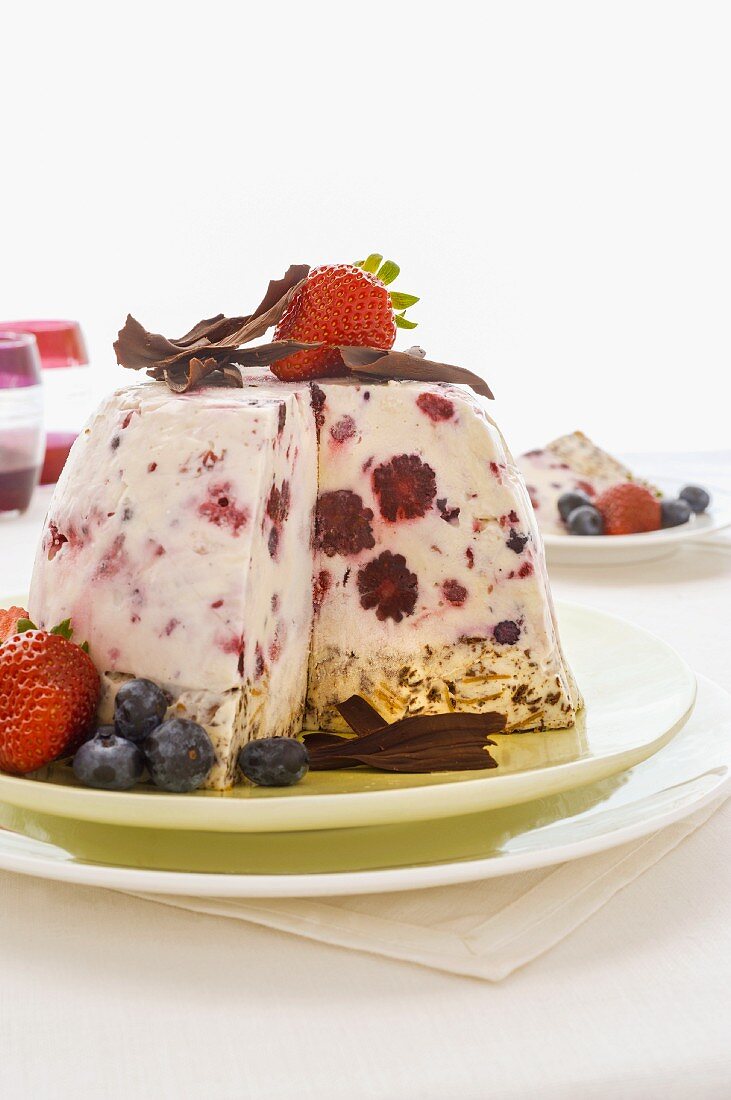 Ice cream bombe with berries, partly slices