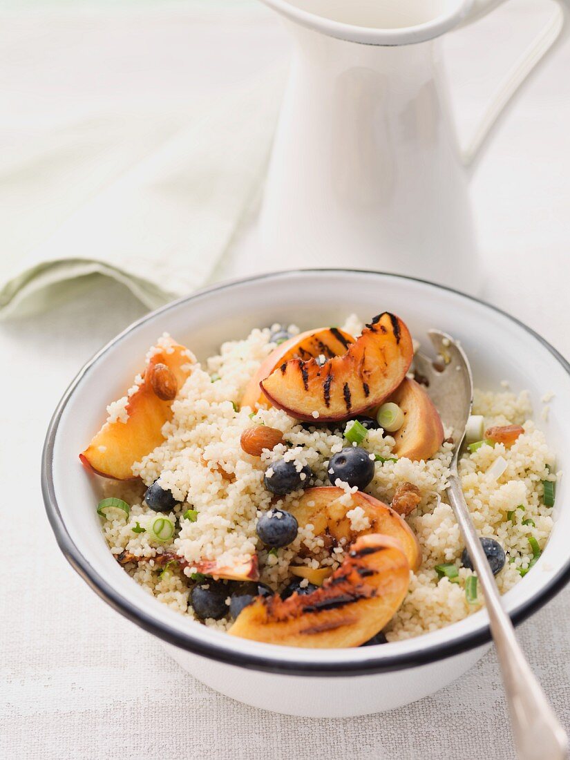 Couscous salad with blueberries and grilled peach wedges