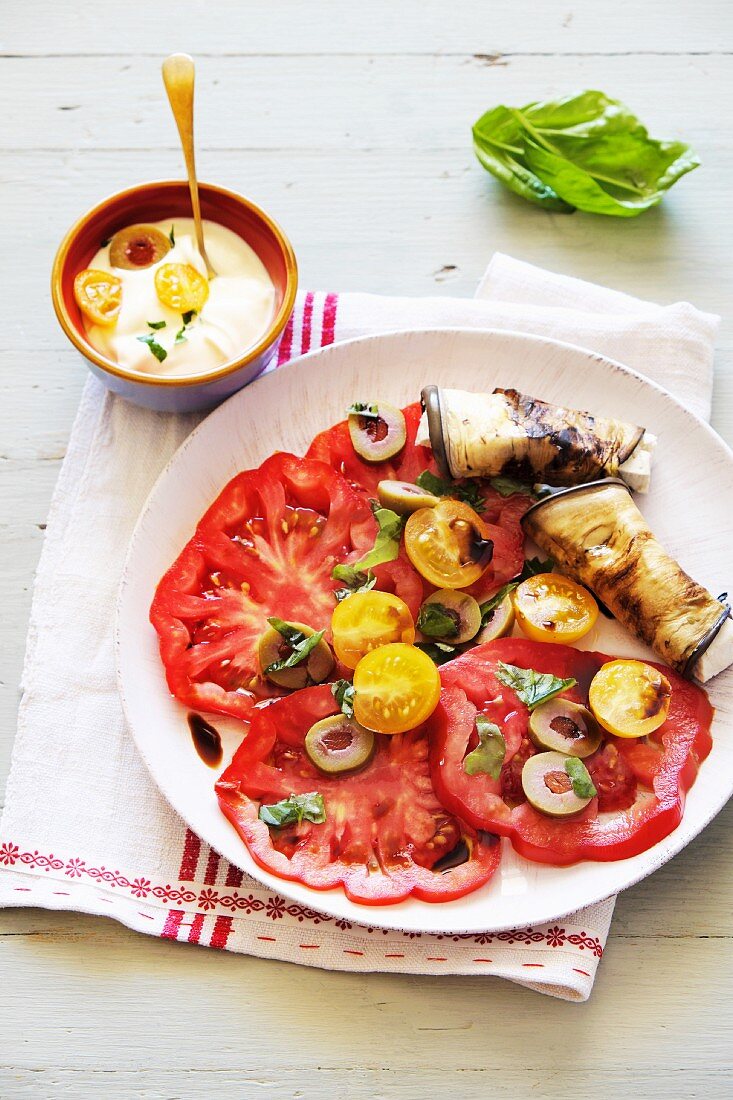Tomato salad with olives and rolled aubergine slices