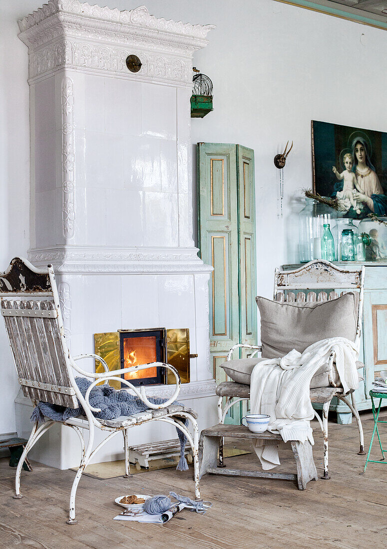 Fireplace in vintage living room with antique furniture and paintings