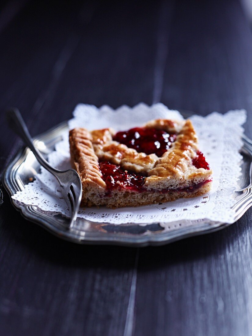 A Linzer Schnitte (nutty shortcrust biscuit topped with jam)