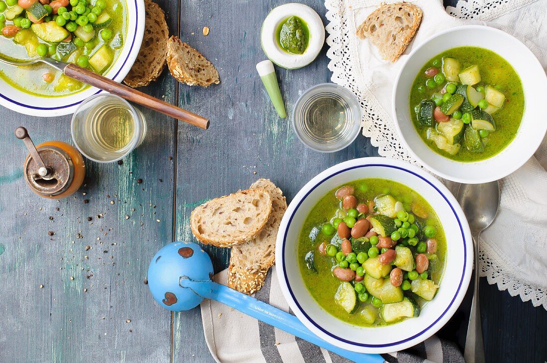 Pesto soup with beans, peas and courgette