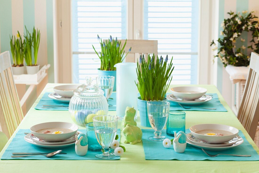 Festively set Easter table with potted grape hyacinths