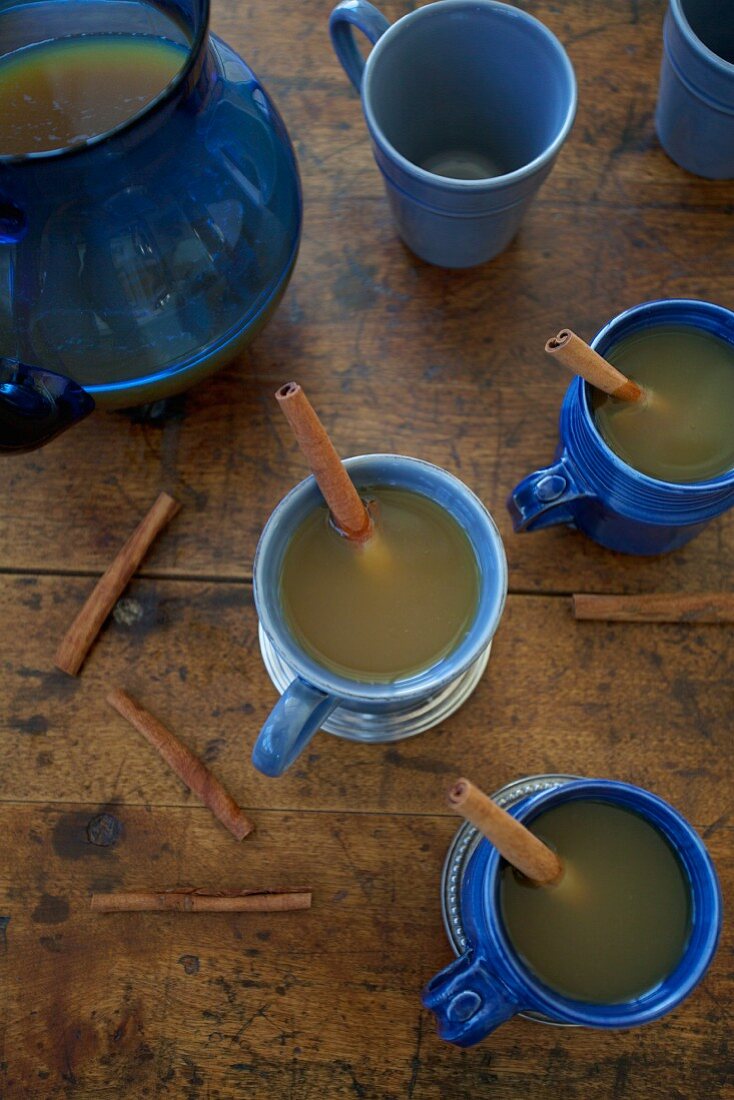 Apple punch with cinnamon in mugs