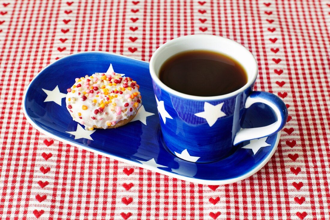 A doughnut and a cup of coffee