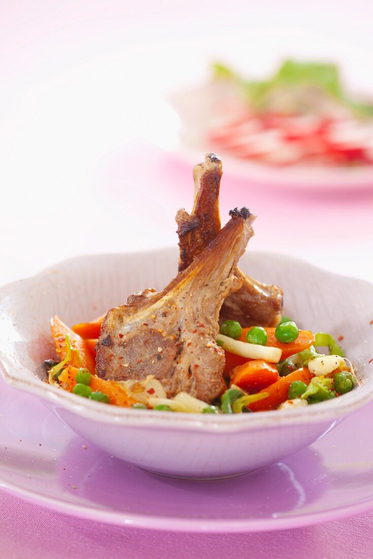 Lamb chops with carrots, peas and parsley root