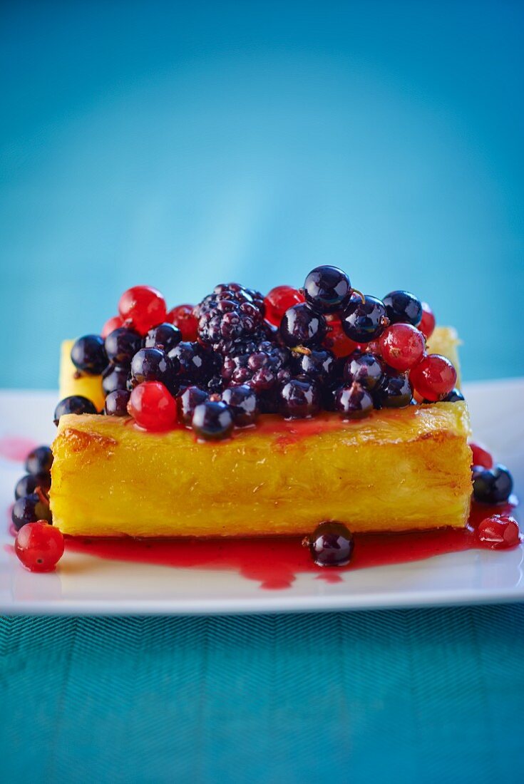 A large piece of pineapple with berries