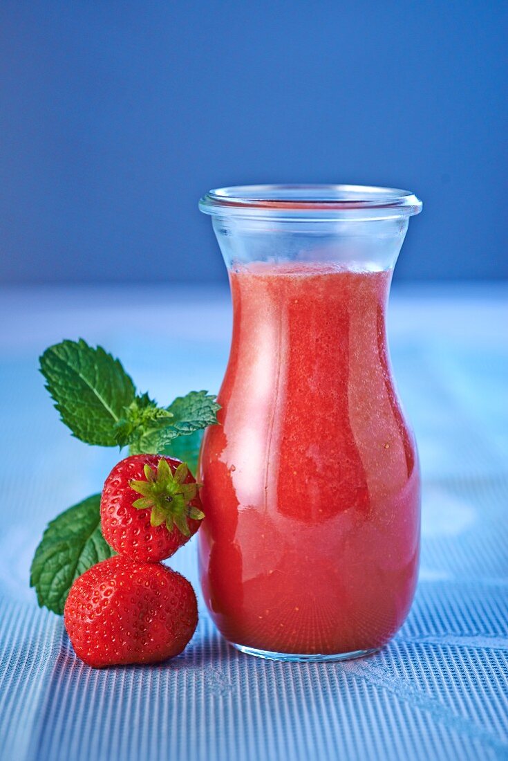 Strawberry smoothie in a small glass carafe