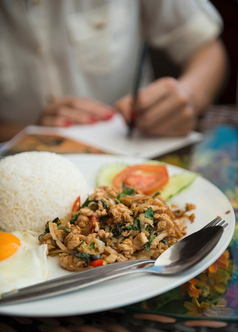 Rice with meat and a fried egg (Laos, Asia)