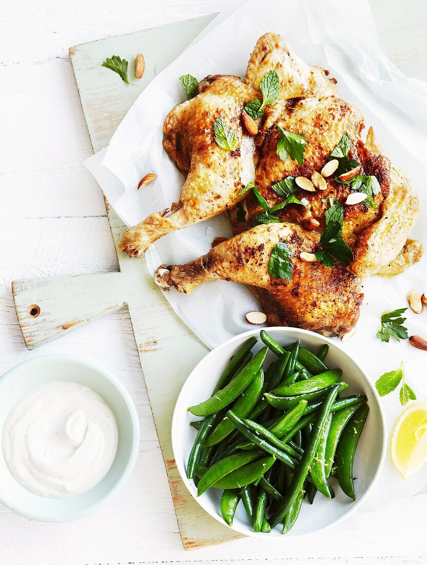 Fried chicken with yoghurt and tahini dressing, lemons and mint