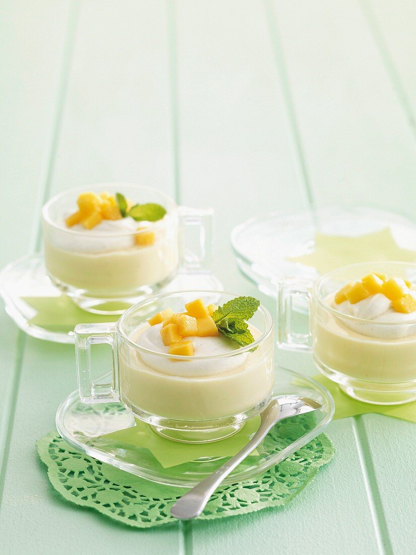Creamy dessert with mango and lemon balm