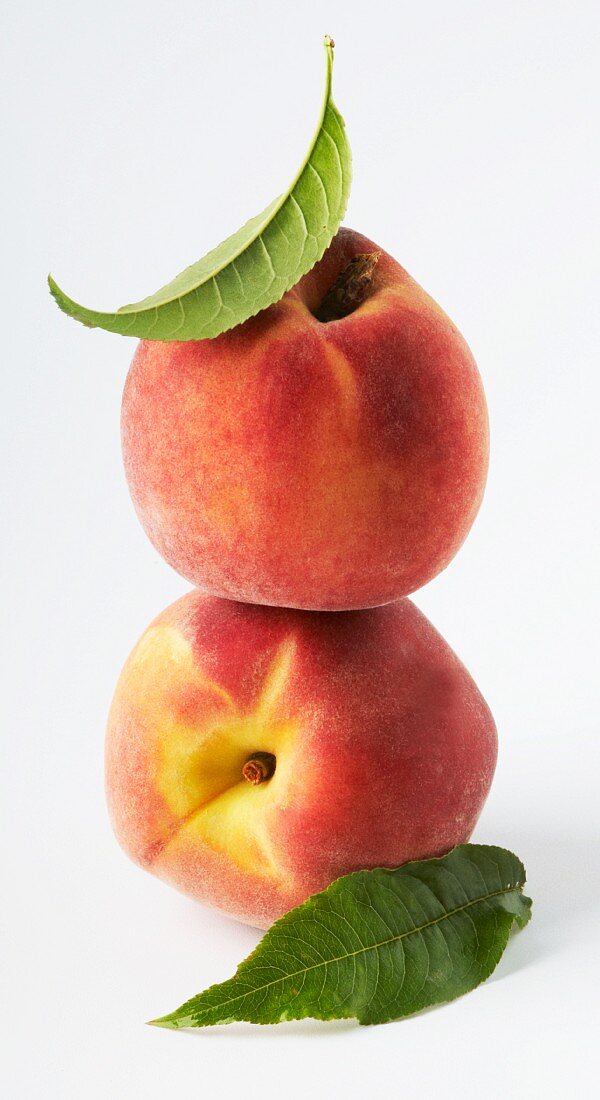 Two peaches, stacked