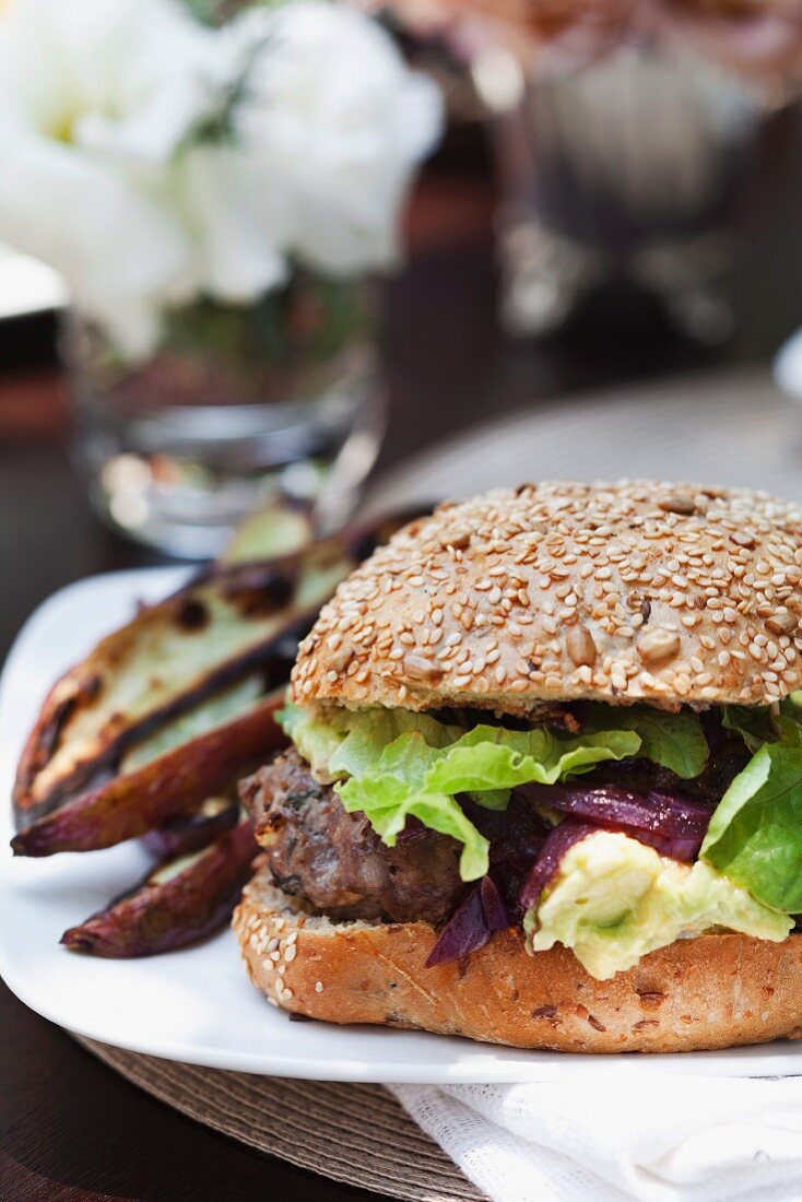 A hamburger with onion confit and lettuce