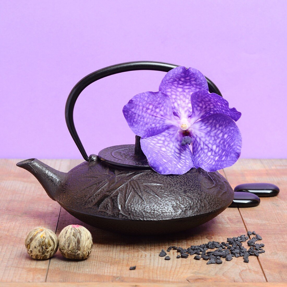 Gusseiserne Teekanne mit lila Orchidee