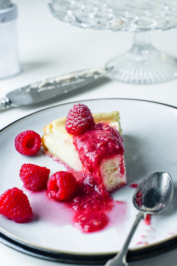 slice of rasberry cheesecake with fresh raspberries