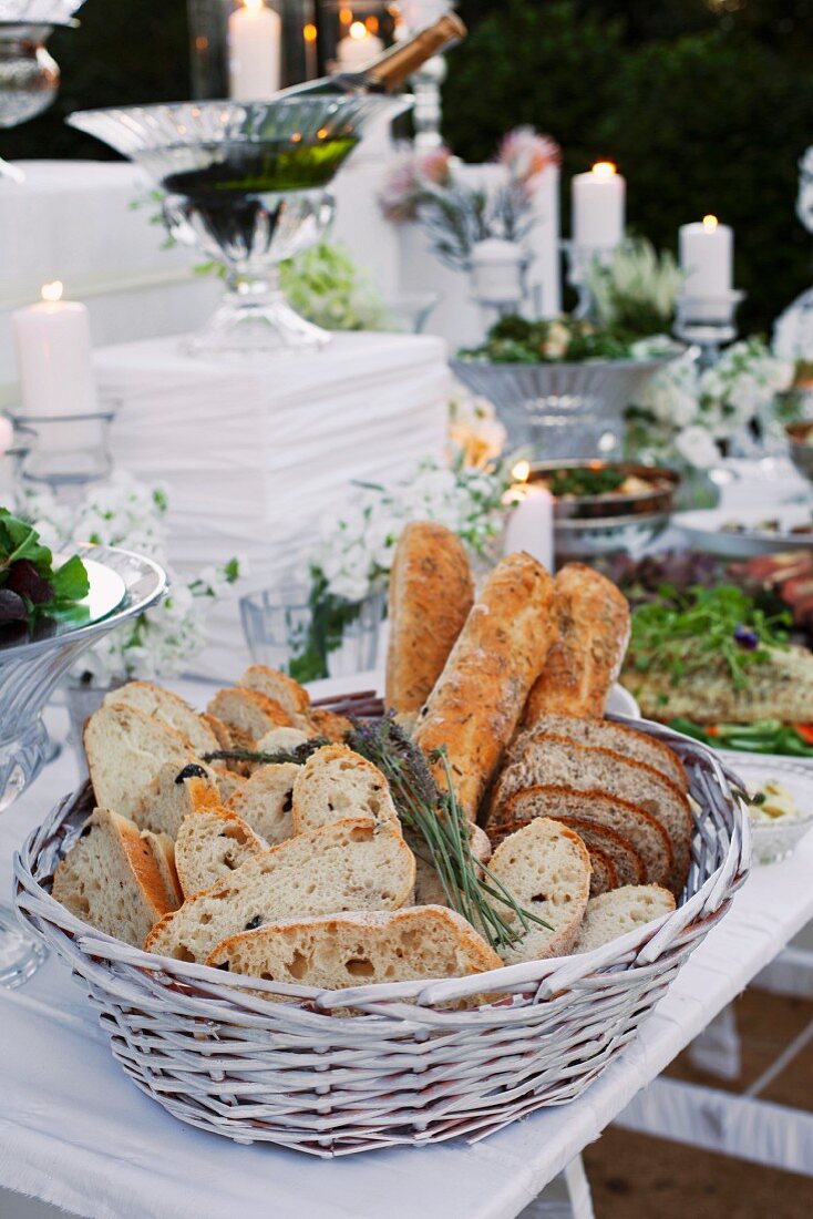 Various types of white bread in a breadbasket on a buffet table