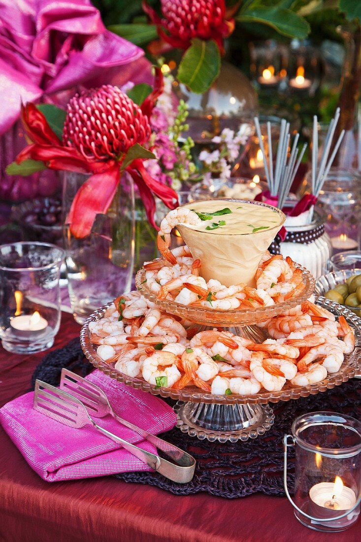 Prawns on a glass stand with cocktail dipping sauce