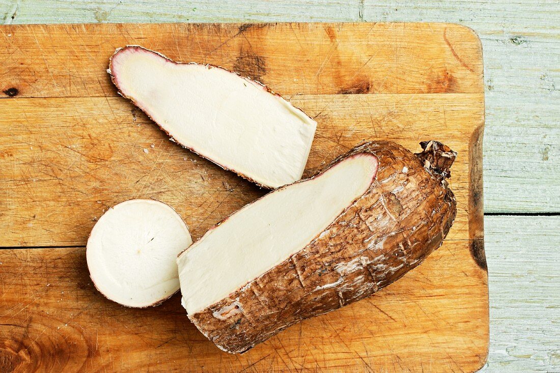 Cassava root, cut open, on a chopping board